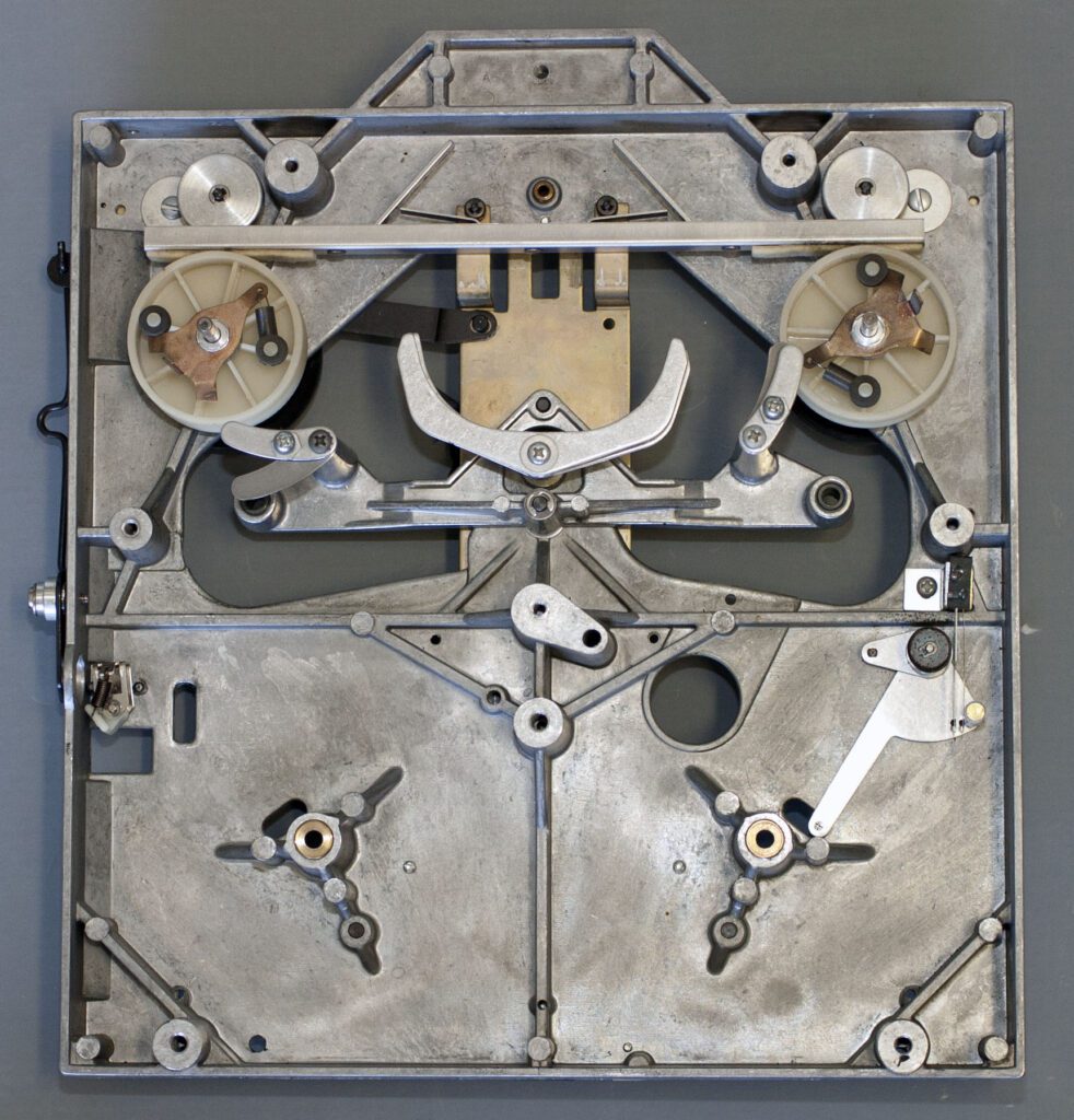 A metal clock face with many gears on it.