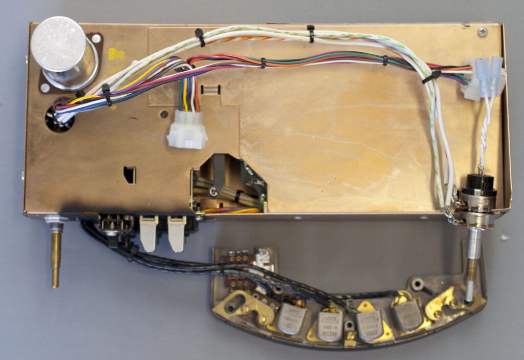 A piece of wood with wires and electrical components attached to it.