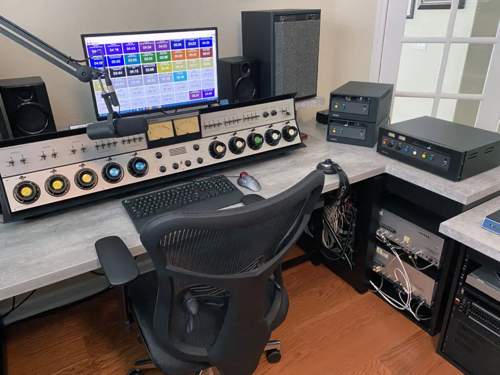 A desk with a computer and chair in front of it.