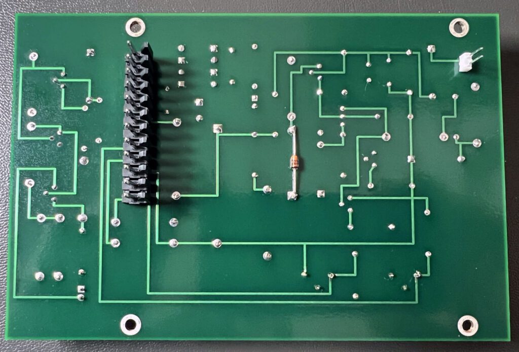 A green board with many wires and some black ones