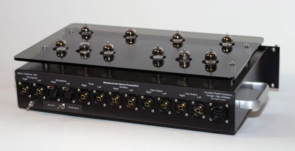 A black and silver stereo system with many knobs