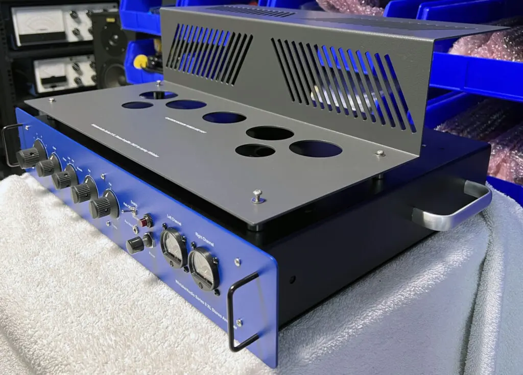 A blue and black amplifier sitting on top of a table.