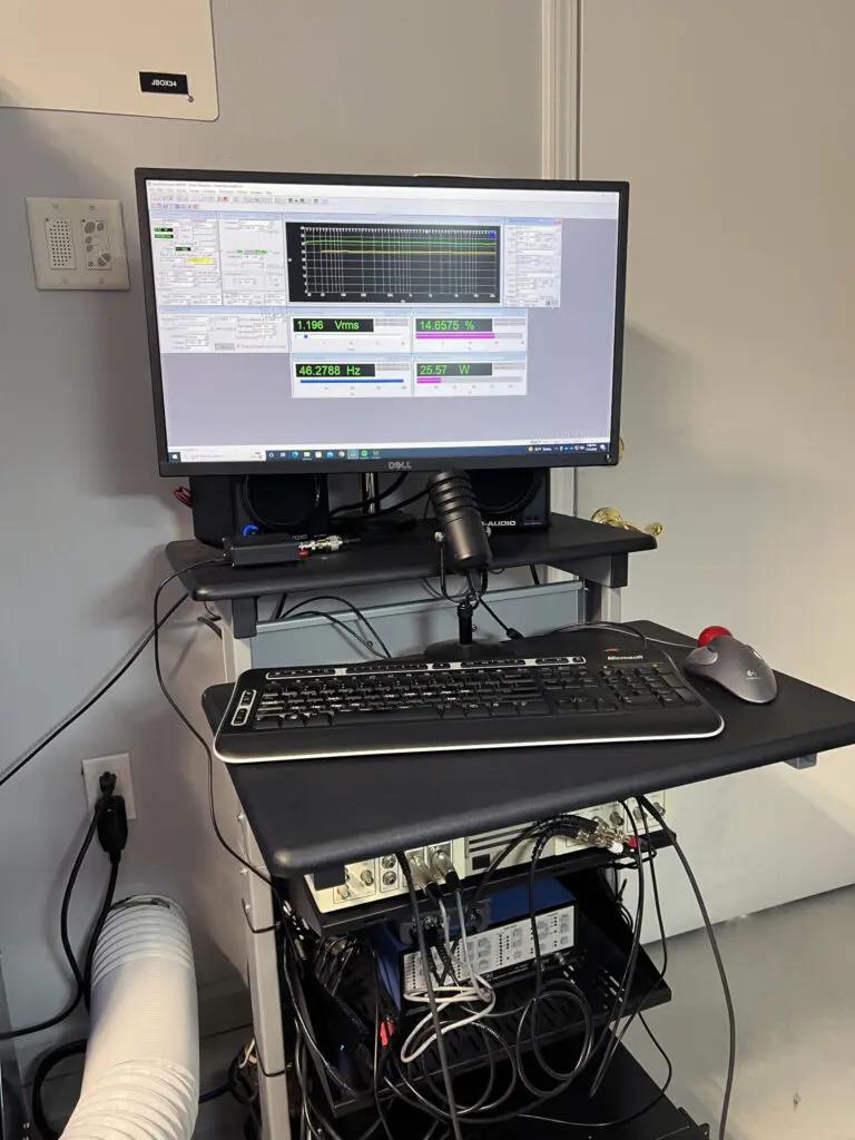 A computer desk with a keyboard and monitor on it.