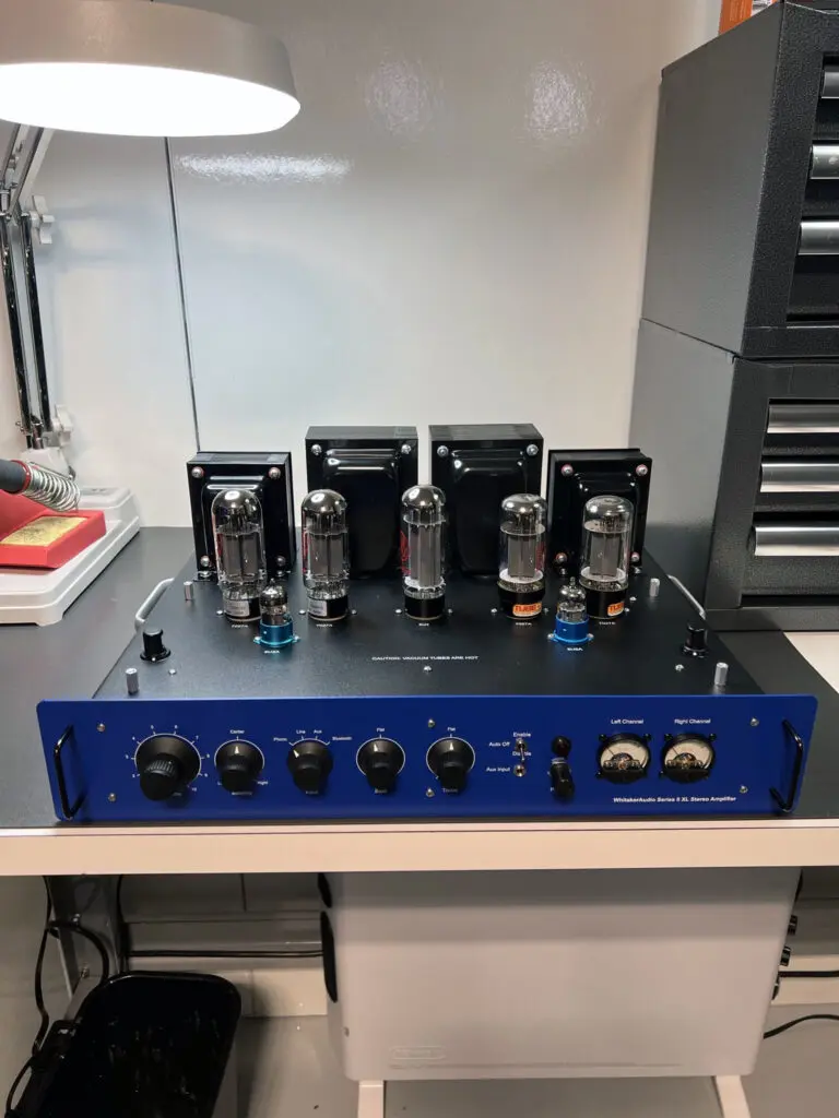 A blue and black amplifier sitting on top of a table.