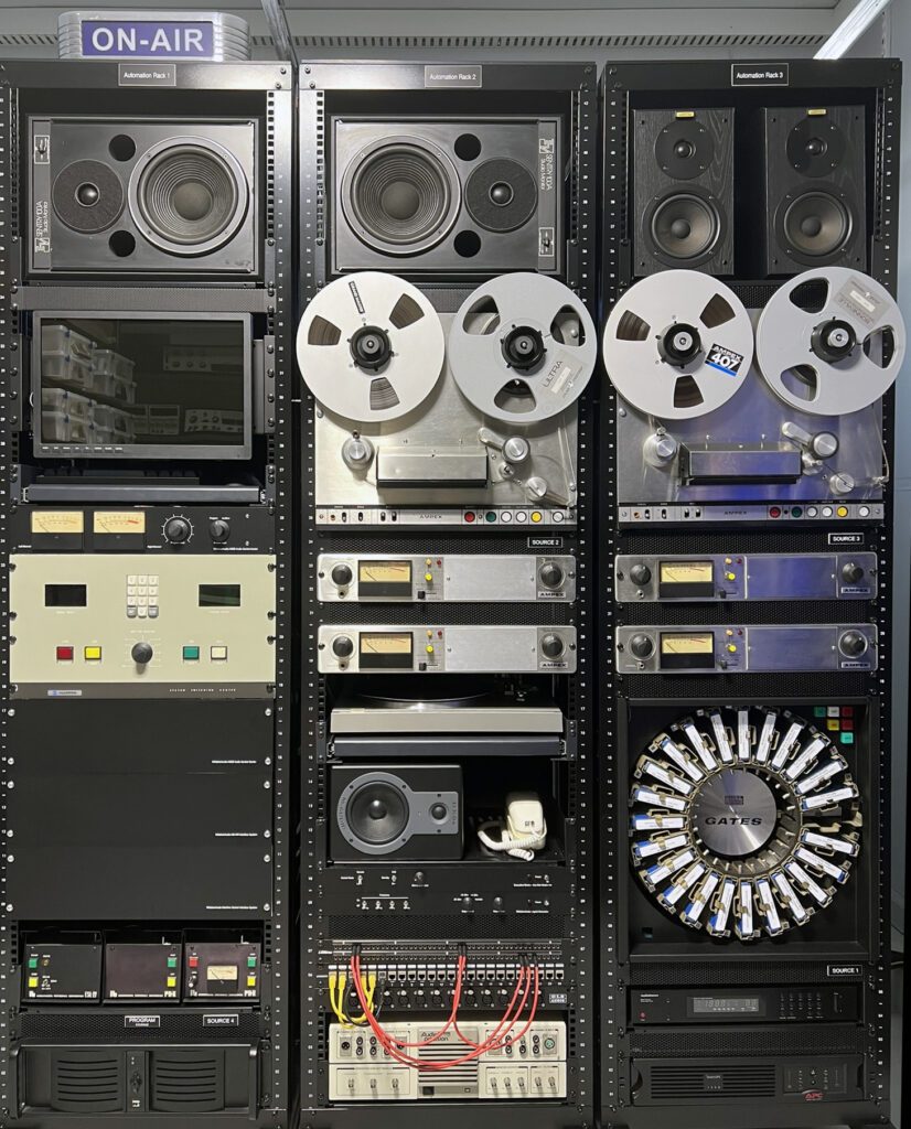 A wall of old stereo equipment with many different types.