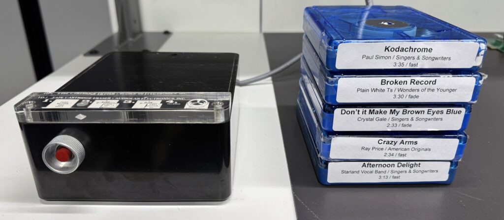 A stack of blue-ray discs next to an ipod.