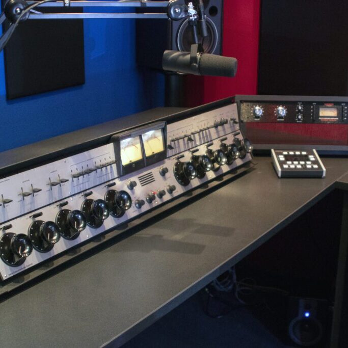 A radio station with two microphones and one mixer.